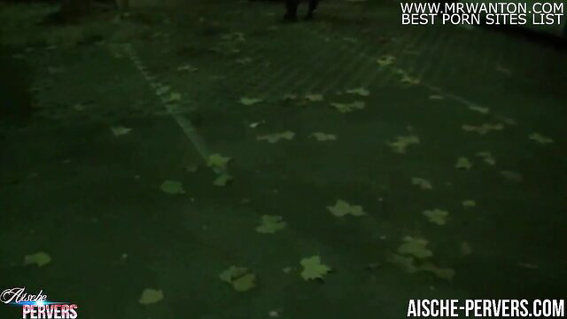 Aische Pervers kneeling outdoors at night, ready for blowjob with strangers in Berlin