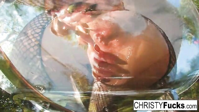 Christy Mack upside down in pool showing wet tattooed body