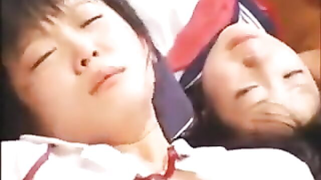 Two cute Japanese girls sleeping intimately in school uniforms