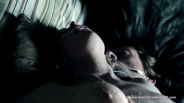 Asian beauty lying nude asleep on bed, exposed breasts closeup