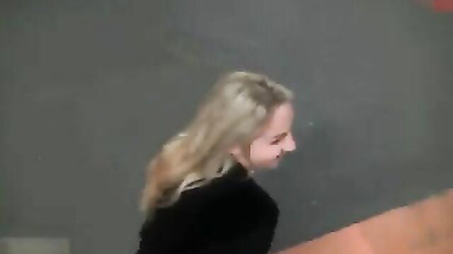 Blonde woman in black top smiling sideways in garage quickie thumbnail