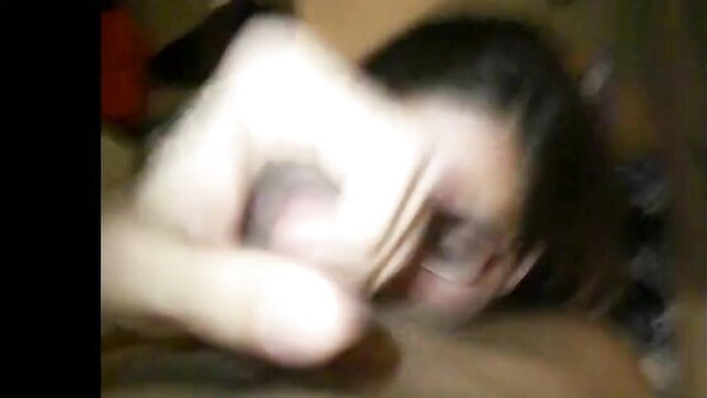 Blurry Asian woman lying down after facial cumshot on face