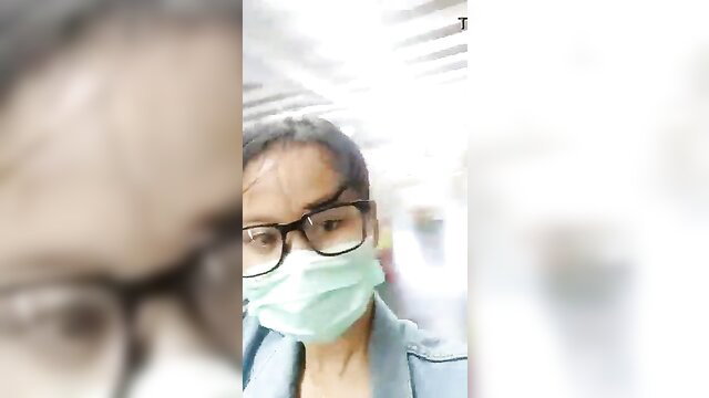 Asian woman in glasses and mask on public transport during pandemic