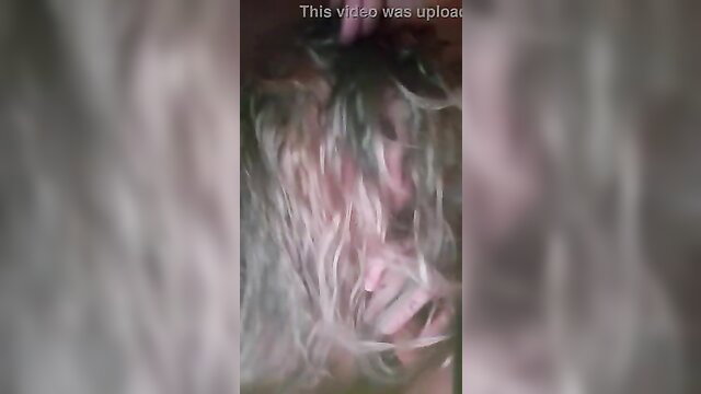 Blurry closeup of woman with gray hair giving messy blowjob