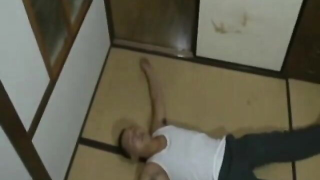 Asian man lying shirtless on floor in amateur Chinese daddy video thumbnail