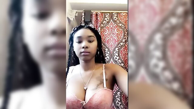 Sexy black babe in pink lingerie bra showing huge cleavage