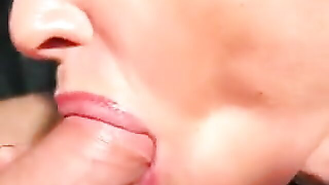 Closeup of woman with glossy lips sucking thick cock in intense blowjob