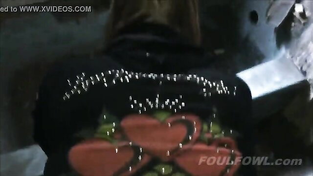 Woman in sparkly hoodie with heart design in abandoned spot