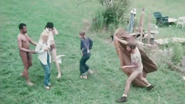 Nude farm orgy chaos: black men grab busty blonde, wild group sex romp