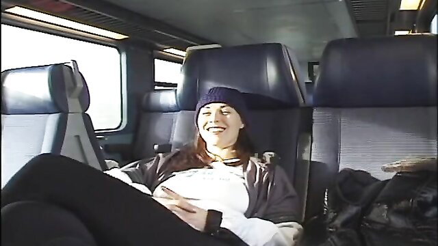 Alisha Klass smiling relaxed on train seat, kinky Euro fun