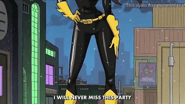 Batgirl in shiny black latex catsuit poses sexy on city rooftop
