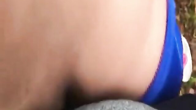 Outdoor closeup of woman's wet shaved pussy in blue thong bikini bottoms