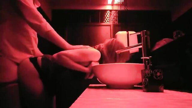 Hotty bent over bathroom sink, ass exposed in thong, red lighting tease