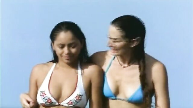 Maya Zapata and brunette in skimpy bikinis beachside, hot Caribe scene