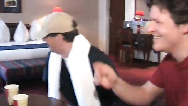 Two smiling men in hotel room, one with towel, sharing girlfriend vibe