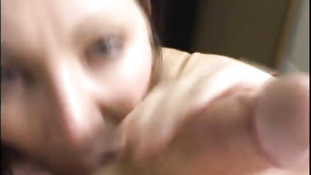 Closeup POV of woman with blue eyes eyeing thick cock up close