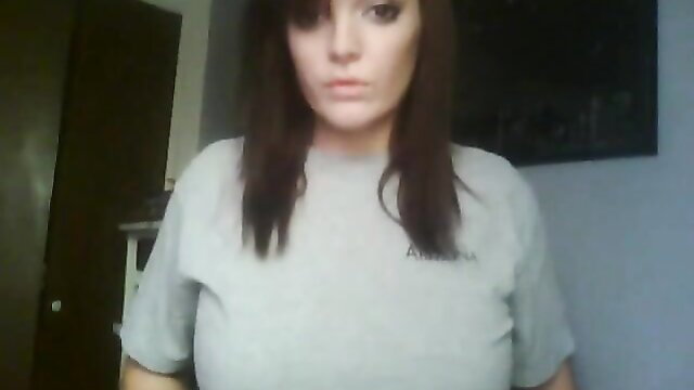 Pretty faced brunette with huge tits in tight gray tee, teasing cleavage