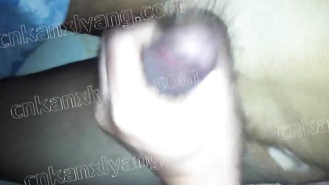 Blurry closeup of Chinese old man's bald head and hand on couch