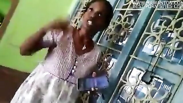 Ebony African woman in dress gesturing passionately on phone