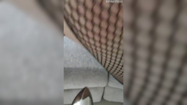 Wife's fishnet stockings ass closeup with high heel, spanking plug tease