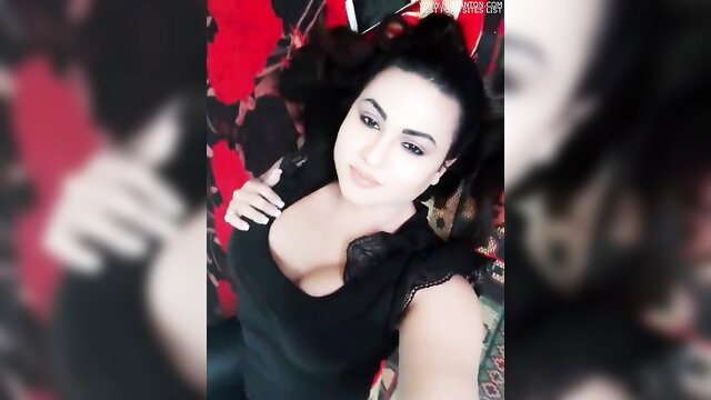 Sexy Indian woman in cleavage-revealing black top selfie