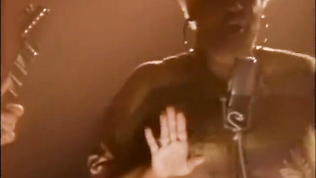 Allyson Is Watching: Black woman on stage with mic, raising hand seductively
