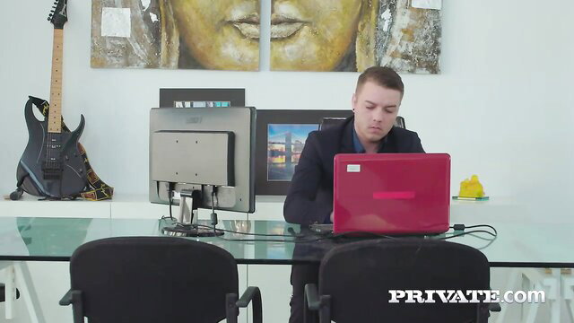 Evelina Darling in office with red laptop, suited up, lingerie anal star