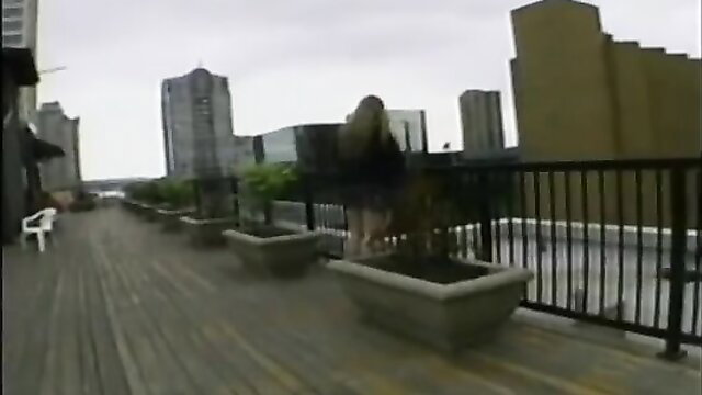 Blonde BBW bends over railing on rooftop, flashing pussy outdoors