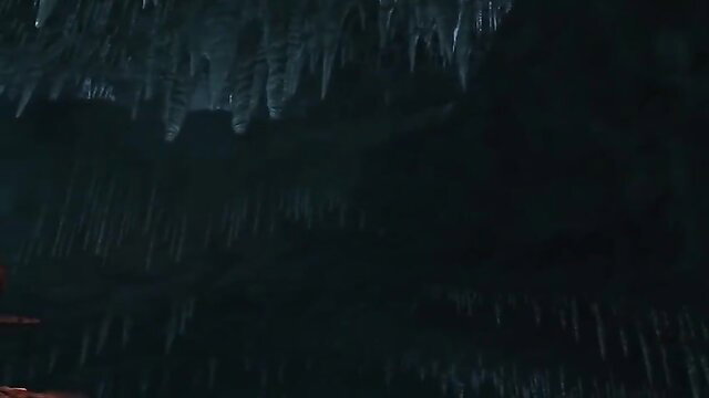 Lara Croft in dark icy Tomb Raider cave adventure, sexy explorer pose