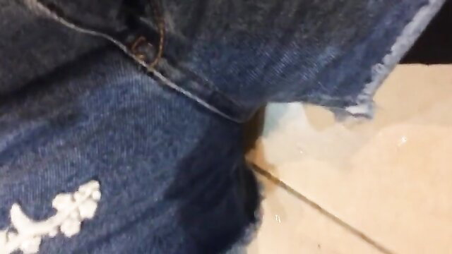 Emma pissing in tight denim shorts, wet pee puddle on floor