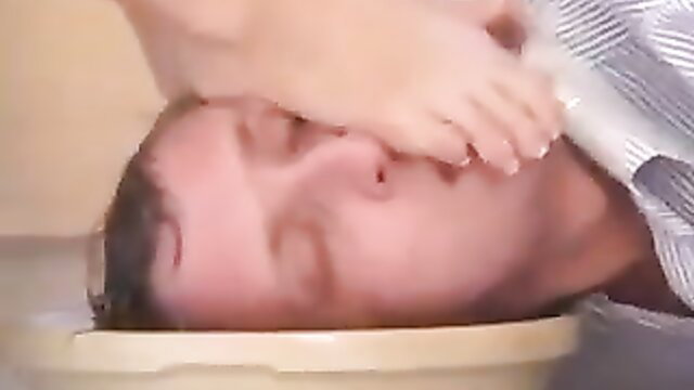 Retired headmistress foot gagging man in basin worship scene