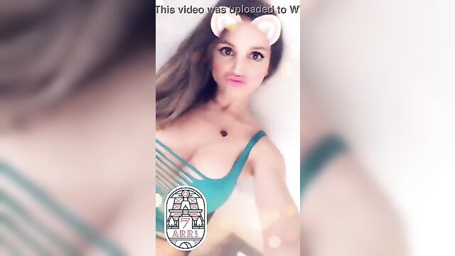 Hot brunette in sexy green chainmail bikini pouting selfie with cat ears