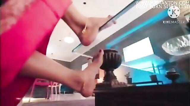 Sexy woman in red saree shows bare feet closeup, horny solo tease