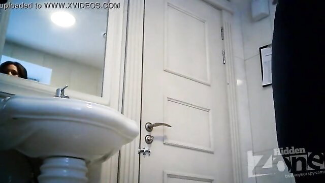 Hidden cam spies on cutie with big ass in bathroom mirror