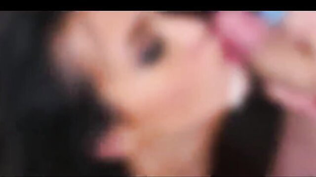 Blurry closeup of woman's face with pink toy near lips in cumshot vid