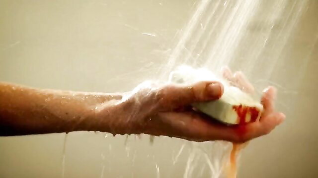 Ana Alexander holding bloody soap in shower, Femme Fatales