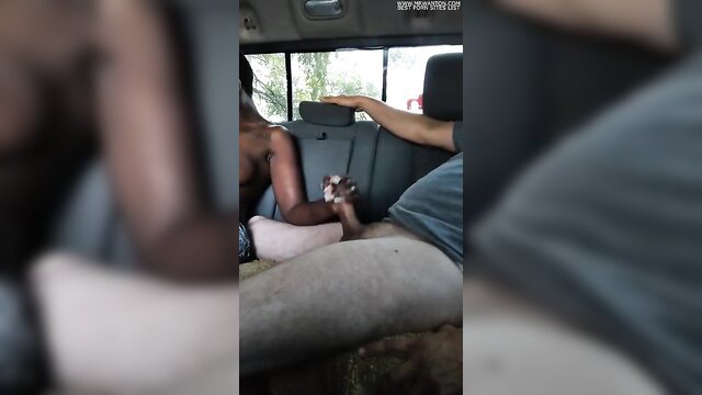 Ebony woman in car grabs man's huge cock, ready to erupt volcano