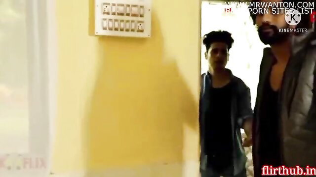 Two Indian men in hallway, bearded guy grabs twink's arm intimately