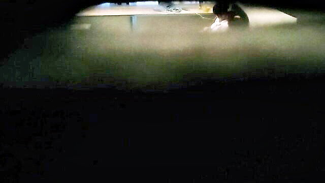 Thai high school teens passionately necking in misty restaurant booth