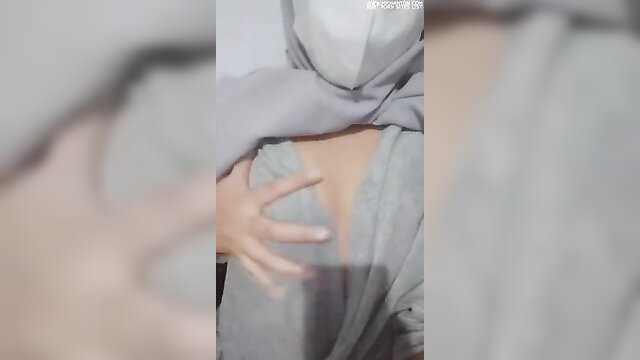 Malay girl in gray tudung lifting top exposing perky tits tease