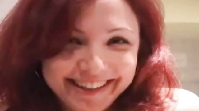 Smiling redhead Euro woman with joyful expression in lesbian video