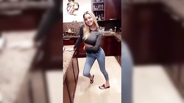 Blonde Emma Mula poses sexy in kitchen, tight sweater jeans
