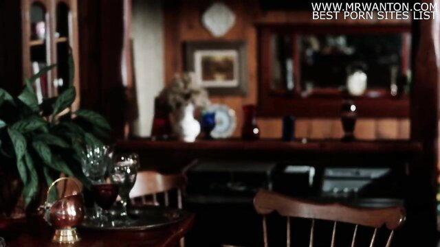 Clothed couple in a dimly lit dining room