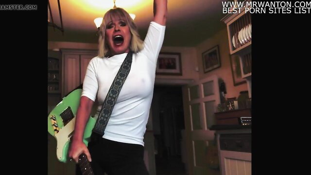 Toyah Wilcox braless in tight white top, rocking green guitar