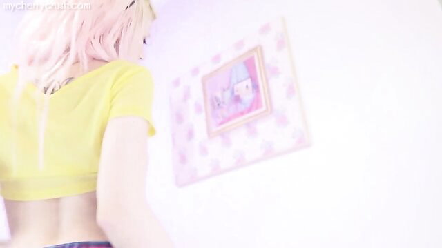 Pink-haired babe in yellow crop top and plaid skirt poses teasingly