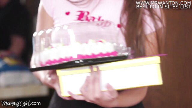 Hot stepmom in pink Babydoll holds cake & gift on anniversary