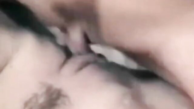 Blurry close-up of couple kissing passionately, nude embrace