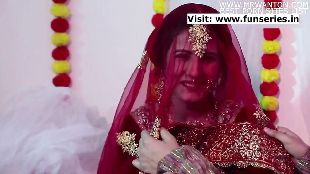 Desi bride in red saree smiles seductively on suhagraat night