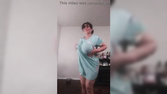 Asian MILF in short teal dress lifting hem flashing papaya pussy