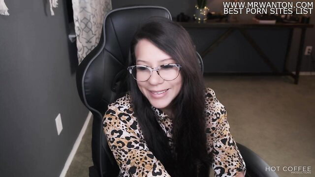 Asian glasses girl in leopard blouse smiles at camera on POV amateur stream